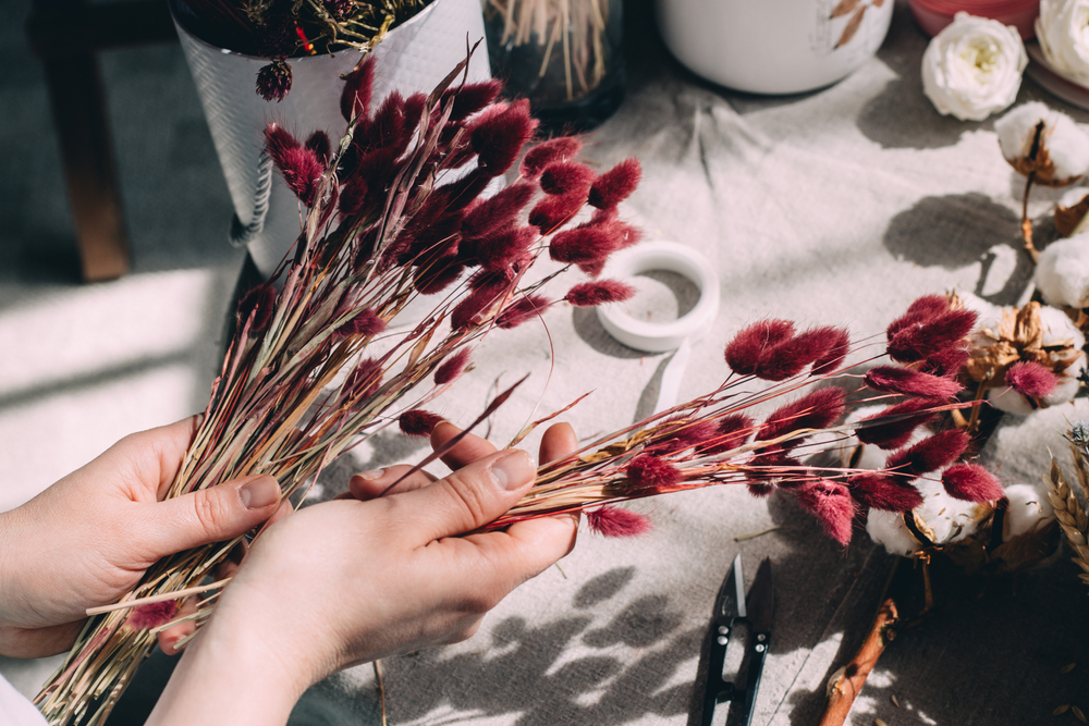 Woman's hands holding small red pampas