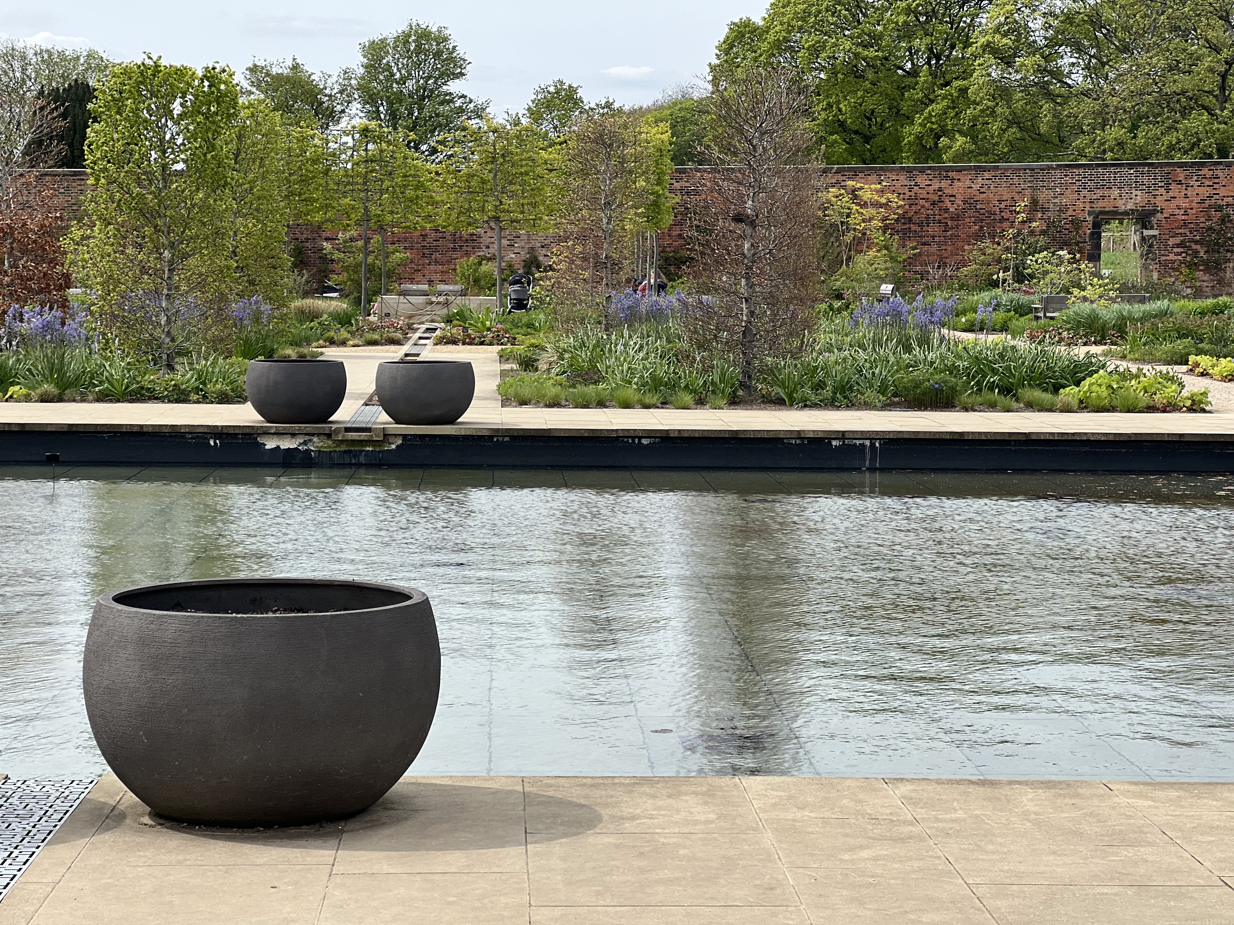 Large pond with planters and trees along the edges