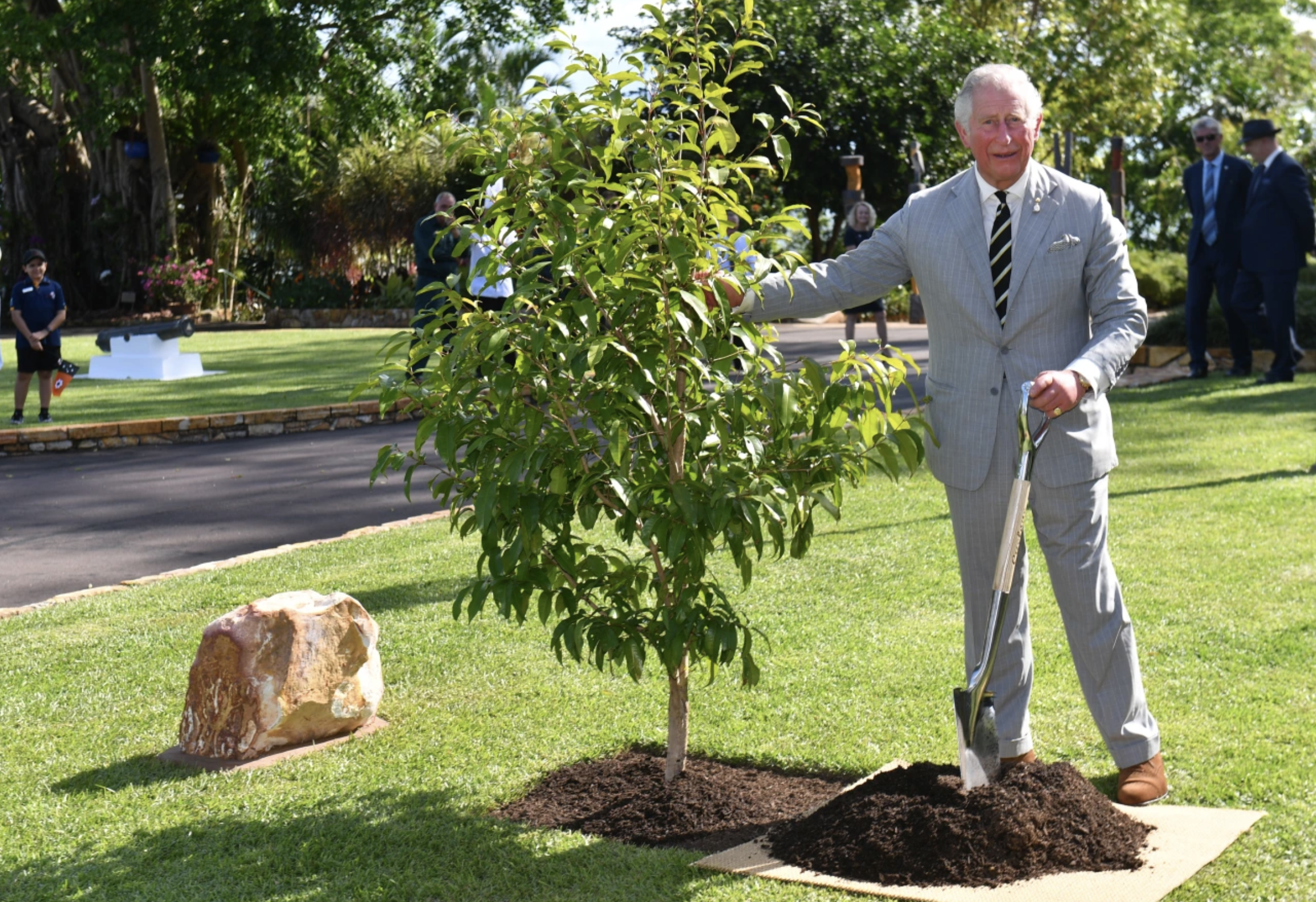 prince charles standing with a young tree and shovel prince charles standing with a young tree and shovel